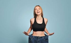 A joyous patient showcasing extreme results from Medical Weight Loss with Semaglutide.