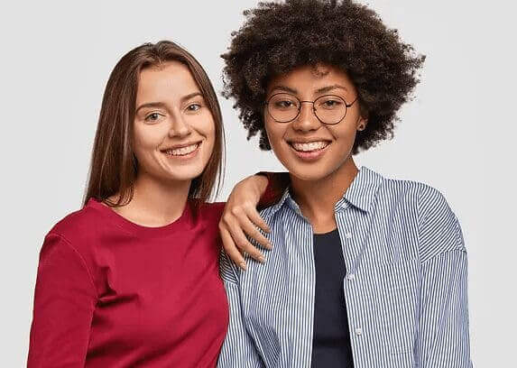 Two beautiful women - NJ Trim Clinic Two smiling women with clear skin and healthy hair representing NJ Trim Clinic wellness results.